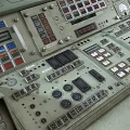 Industrial Control Console With Multiple Displays Control Panels Buttons And Green Beige Design