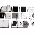 Assorted Open And Closed Notebooks With Pens Pencils Coffee Mug And Stationery