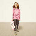 Cheerful Girl In Pink Long Sleeve Top Holding Polka Dot Cloth Standing On Beige Floor
