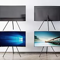 Modern Televisions on Tripods Some Displaying Scenic Images Against White Wall