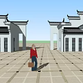 Traditional Chinese Symmetric Buildings Around Stone Paved Courtyard With Person Standing