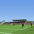 Soccer Field With Players In Action During Match With Spectators In Stands