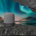 Transparent Dome Speaker Placed On Rocks With Aurora Borealis Snowy Mountains And Lake