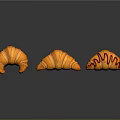 Sculpture Carving Of Three Orange Croissants With Striped Surface Design Details