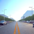 Wide Municipal Road With Two Way Lanes Yellow Dividing Lines Street Lights Trees And Vehicles