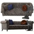 Elegant Dark Gray Tufted Sofa with Brown Blue Pillows and Gray Blanket