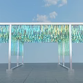 Event Entrance with Colorful Blue Green Hanging Decorations and White Pillars Under Blue Sky