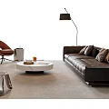Modern Brown Leather Sofa With Round Marble Coffee Table Armchair Floor Lamp And Potted Plant