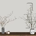 Gray And White Patterned Ceramic Vases With Flower Branches On Wooden Table Against Light Wall