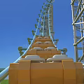 Amusement Park Roller Coaster with Green Tracks and Steel Structure under Blue Sky Green Grass