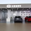 BYD Garage Showroom Interior With Two Gray And Red Cars And Lighting