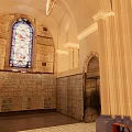 Sacred Church Interior With Stained Glass Window Arched Structures And Memorial Walls