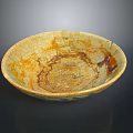 Sculpted Ceramic Bowl With Yellow And Brown Texture And Intricate Surface Patterns