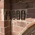 Romanesque Entrance Gate With Red Brick Structure Carved Archway Stone Columns And Wooden Doors