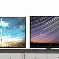 Two Televisions on White TV Stands with Scenic Displays of Sky Grass and Star Trails