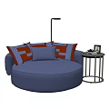 Round Blue Single Sofa Featuring Orange And White Patterned Cushions And Small Side Table