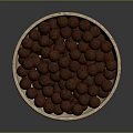 Natural Beige Stone Bowl Filled With Brown Nuts Against Dark Background