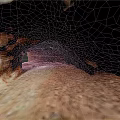 Red Rock Cave Interior With Natural Arch Gravel Floor And Entrance Light
