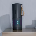 Sleek Black Portable Speaker With Leather Strap Colorful Sound Wave Design And Wireless Charging Pad