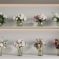 Various Glass Vases With Colorful Flowers Displayed On White Shelves For Home Decor