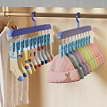 Pink Knit Hat with Bear Embroidery and Colorful Socks on Blue Hangers in Closet