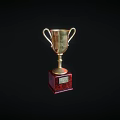 Golden Trophy With Two Handles And Red Base On Black Background
