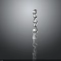 White Decorative Spiral Structure With Reflective Base On Dark Background