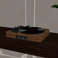 Vintage Turntable With Black Vinyl Record On Wooden Table Near Green Plant And Lamp