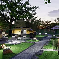 Scenic Campsite With Camper Van Tents Green Grass Pathway Trees And Evening Lighting