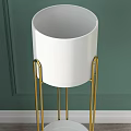 Blue Ceramic Planters On Gold Metal Plant Stands In Modern Room With Gray Curtains