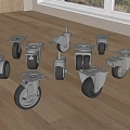 Various Metal Casters With Swivel And Fixed Wheels On Wooden Floor