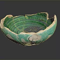 Broken Ceramic Bowl With Green And White Glaze Cracks And Chips