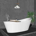 White Freestanding Bathtub With Gray Stone Wall Hanging Lamp And Green Plant On Pebble Floor