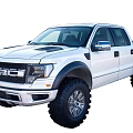White Ford Pickup Truck With Off Road Style Wide Fender Flares And Large Tires