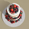 Two Tiered Naked Cake Decorated With Fresh Strawberries And Blueberries On Round Platter