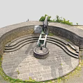 Historic Military Weapon Ancient Cannon on Circular Stone Platform With Stone Walls and Green Plants