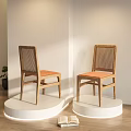 Modern Dining Chairs With Wooden Frame Rattan Backrest And Orange Cushion On White Display Stand