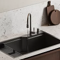 Modern Kitchen Sink With Sleek Faucet White Textured Countertop Wooden Cutting Boards And Plate