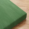 Green Sectional Sofa With Textured Fabric Upholstery On Wooden Floor