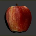 Fresh Juicy Red and Yellow Apple with Striped Skin and Brown Stem on Dark Background