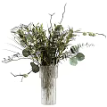 Fresh Flower Arrangement In Clear Textured Glass Vase With Eucalyptus Leaves White And Purple Blossoms