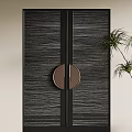 Modern Textured Black Double Doors With Round Metallic Handle And Green Plant