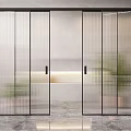 Modern Glass Sliding Doors With Black Frames And Frosted Vertical Stripes In Interior Space