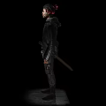 Man With Red Hair In Black Jacket And Tactical Gear Standing On Dark Background
