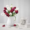Fresh Red And White Tulips In White Vase With Ornate Photo Frame And Scattered Petals