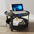Black Round Two Tier Coffee Table With Laptop Books And Scented Sticks