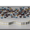 Colorful Butterfly Art Installation With White Base And Wing Shaped Design