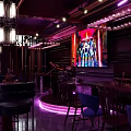 Stylish Bar Interior Design With Purple Lighting Chandeliers Wine Racks And Furniture