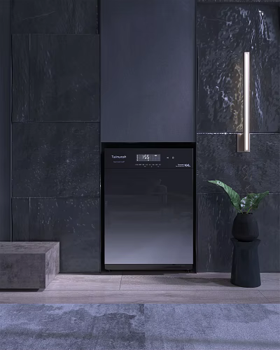Sleek Black Washing Machine Against Dark Stone Wall With Green Plant 3d model