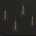 Modern Glass Pendant Lights With Teardrop Shape And Brass Finish On Dark Background